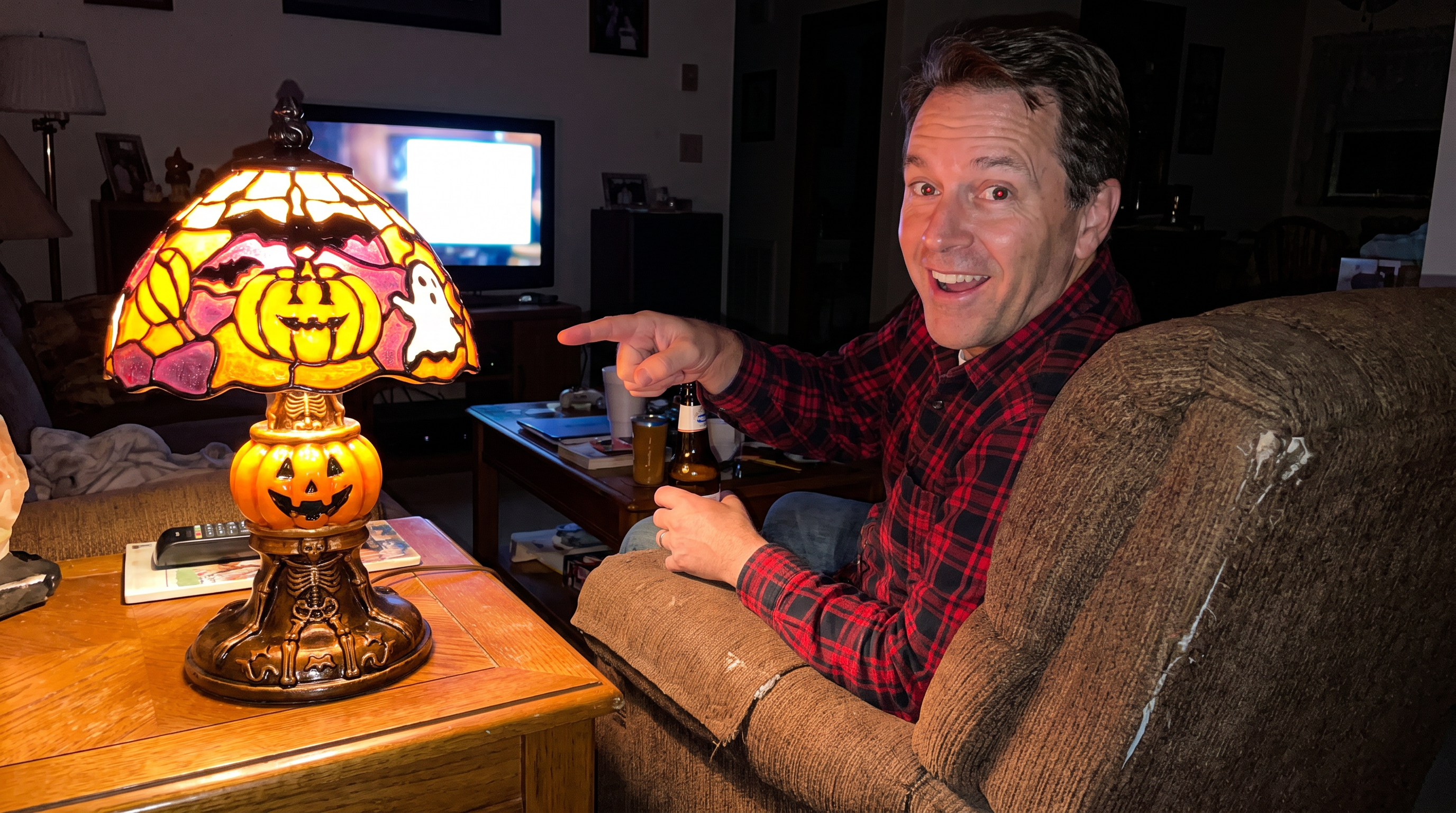 Customer in an armchair pointing at the lit lamp