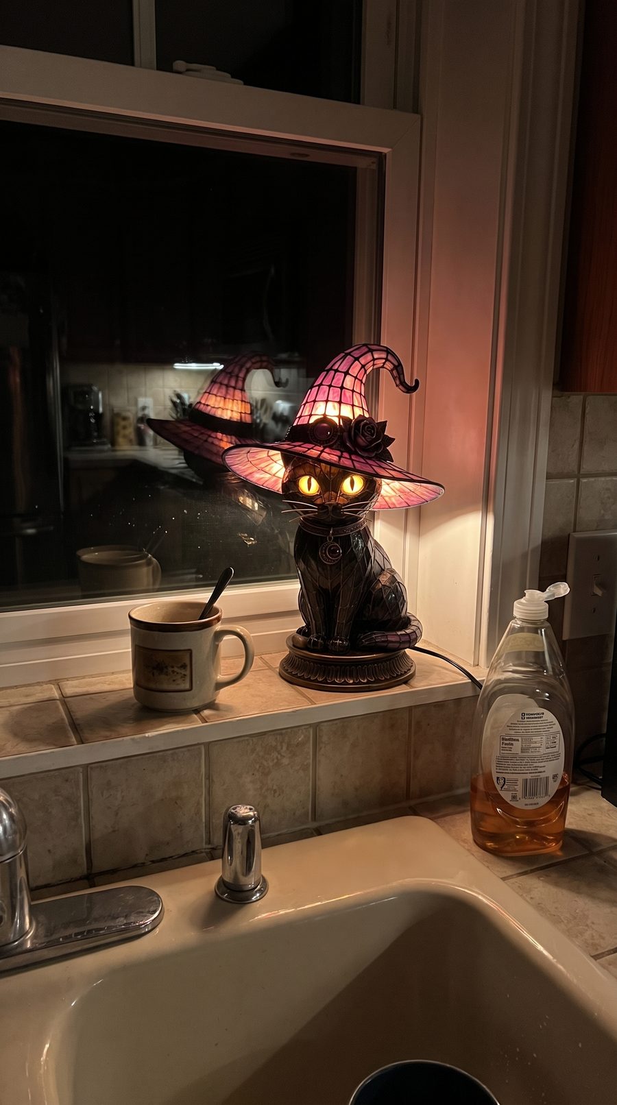 Customer photo: the lamp lit on a kitchen windowsill at night
